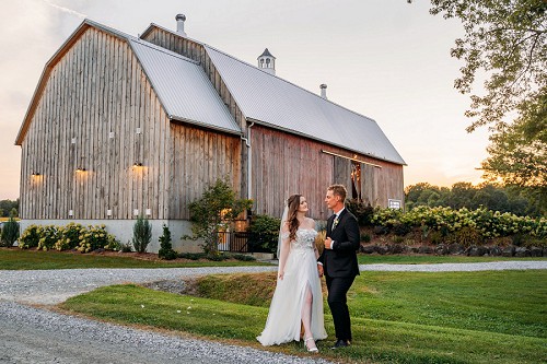 wedding portrait in front of barn at kehoe and kin