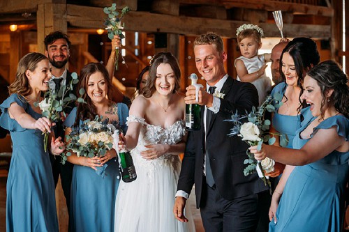 champagne celebration inside barn at kehoe and kin