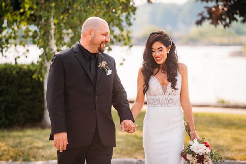 bride and groom walking at sugarloaf marina