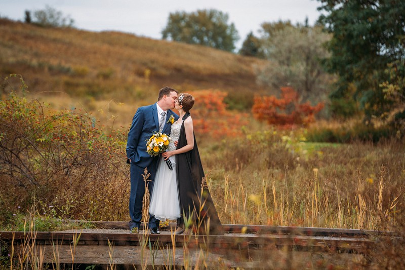 couple kissing on bridge