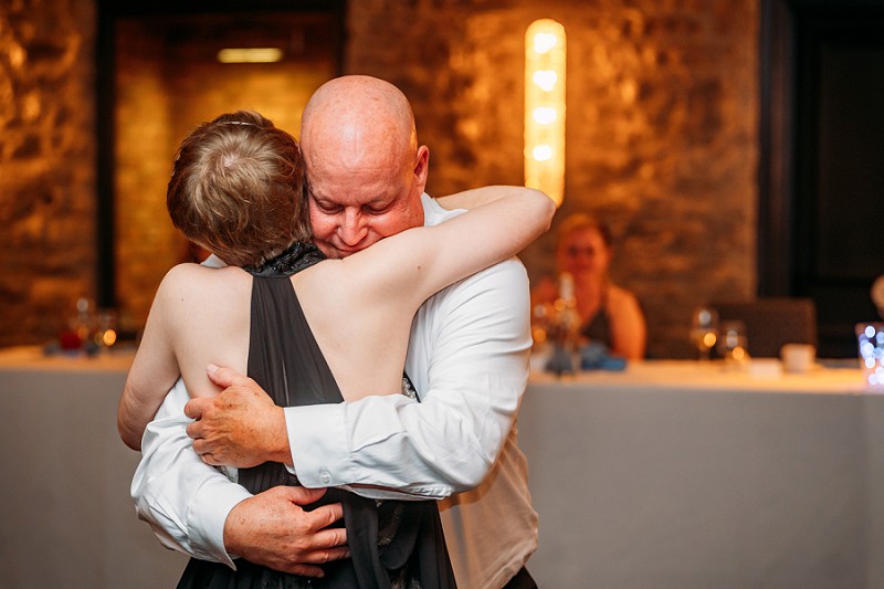 father hugging bride