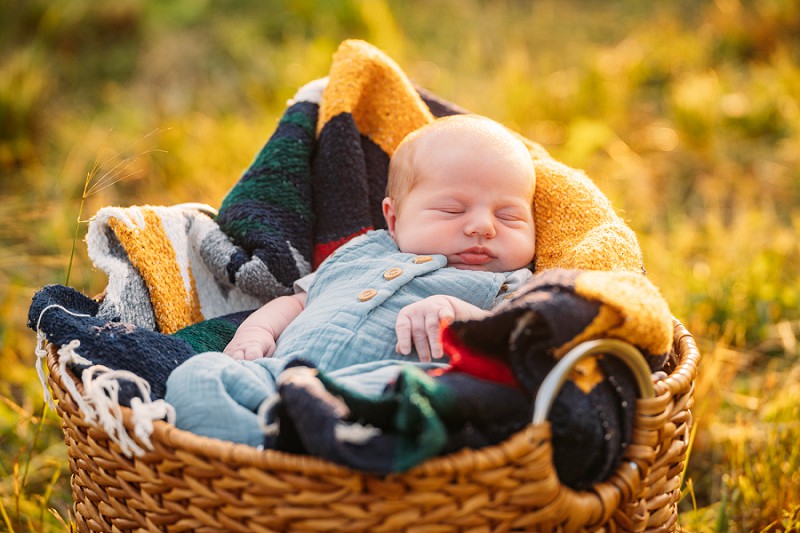 baby sleeping outside in basket