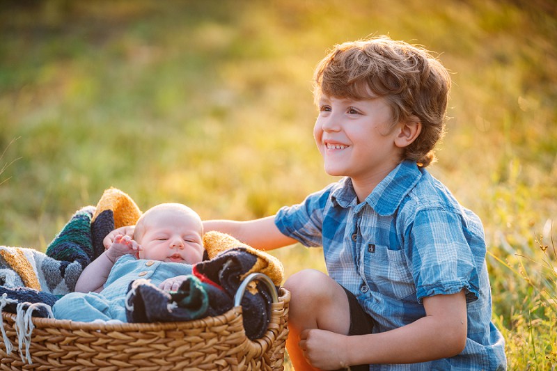 brother smiling at baby