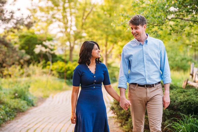couple walking and laughing while holding hands