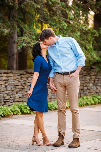 couple kissing while she holds her dress