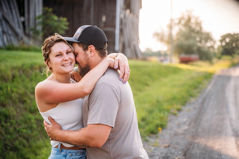 girl looking at camera with barn in background