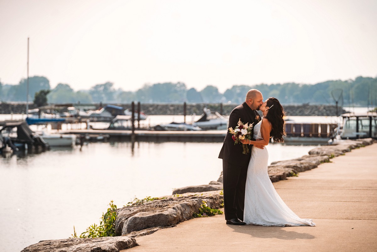 bride and groom kissing at port colborne marina