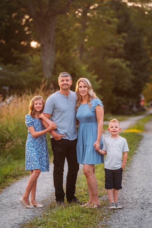 family holding hands along a trail