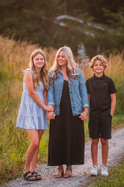 mom holding hands with her kids