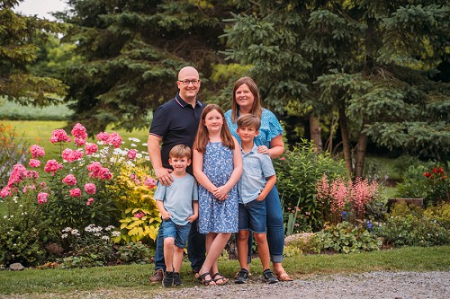 family portraits in front of garden