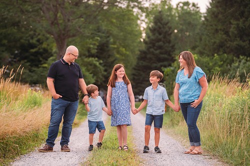 family smiling holding hands