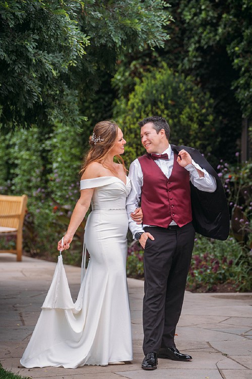 bride holding her dress looking at groom