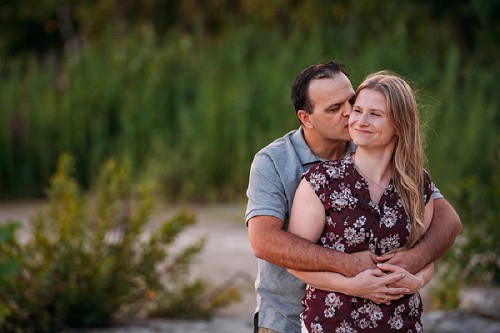 man kissing fiance on the cheek