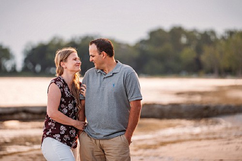 man and woman smiling at each other on the beach