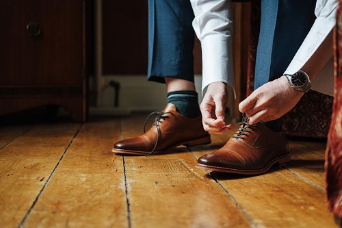 groom putting on shoes