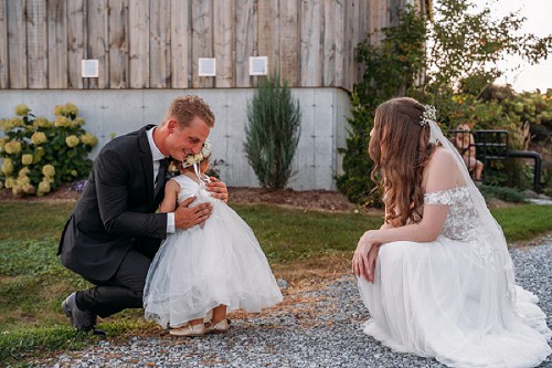 flower girl hugging groom