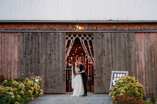 couple in front of barn doors