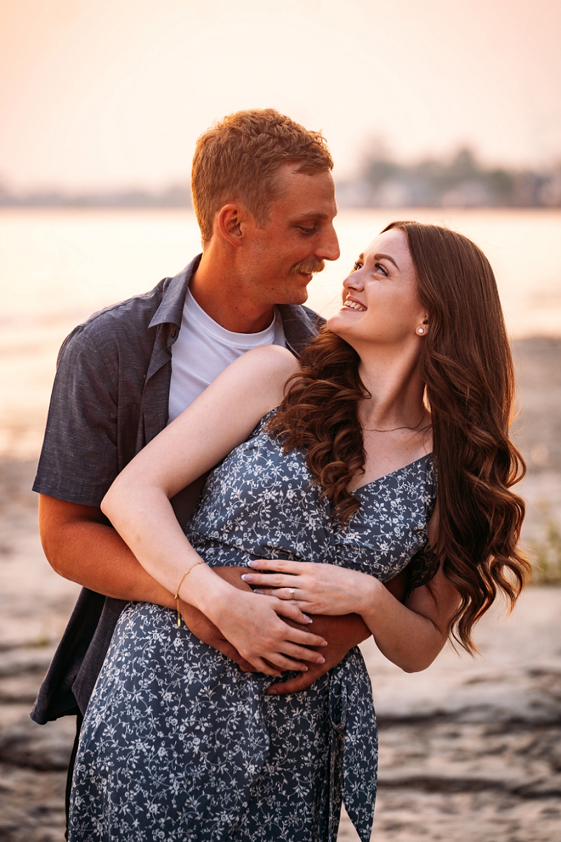 couple holding each other and laughing while on the beach