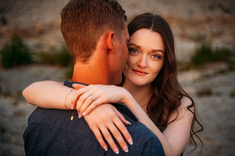 bride looking at camera showing ring