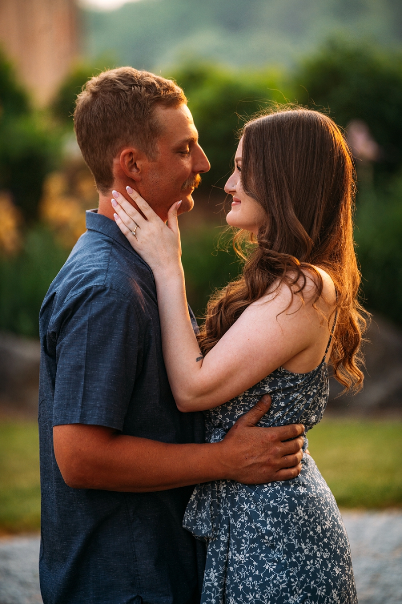 couple looking at each other while girl holds his face