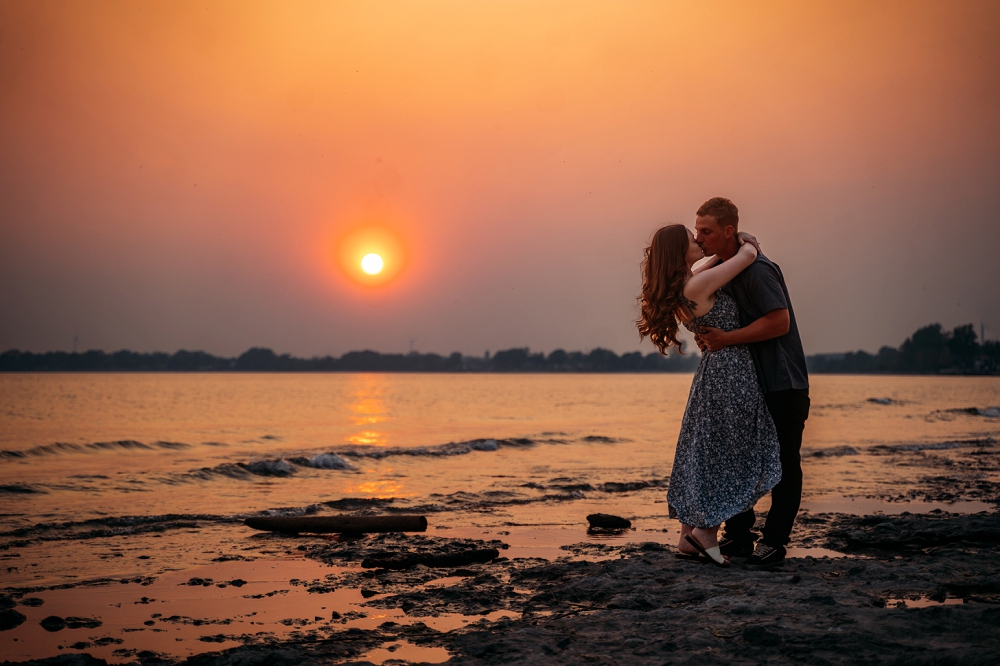 southern ontario engagement shoot on the beach with smoke from the wildfires in the sky