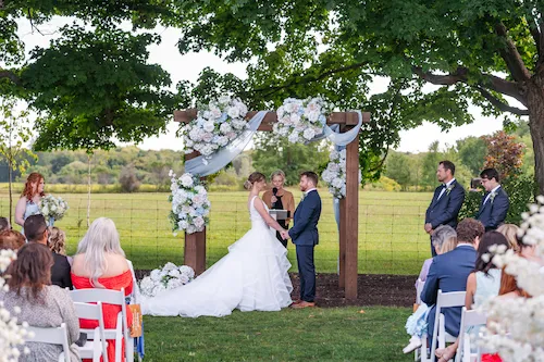 Outdoor wedding ceremony in the Meadow at Maple Meadows Farm in Port Colborne, Ontario