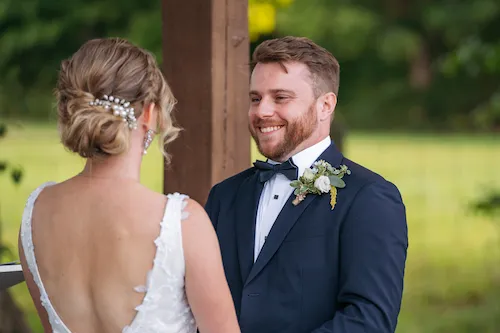 groom smiling at bride