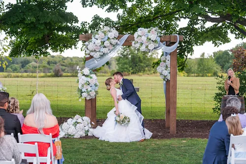 bride and groom sharing their first kiss after the ceremony in the Meadow