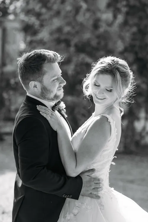 black and white portrait of bride and groom embracing each other at Maple Meadows