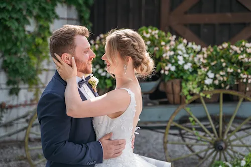 bride and groom about to kiss in the gardens at Maple Meadows