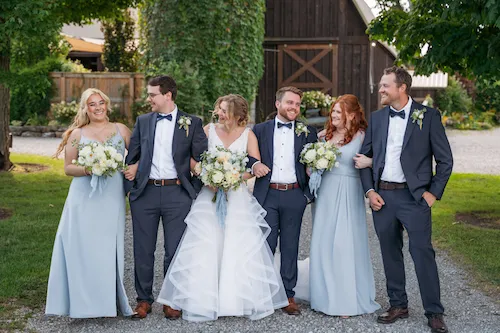 Wedding party group photo with everyone laughing at Maple Meadows Farm