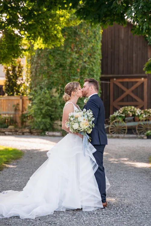 Bride and groom couple portraits on the driveway at Maple Meadows Farm in late summer