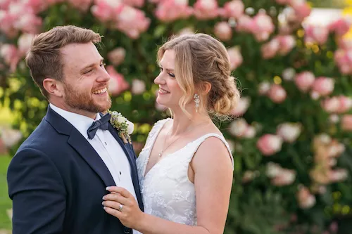 bride and groom laughing in the gardens at Maple Meadows
