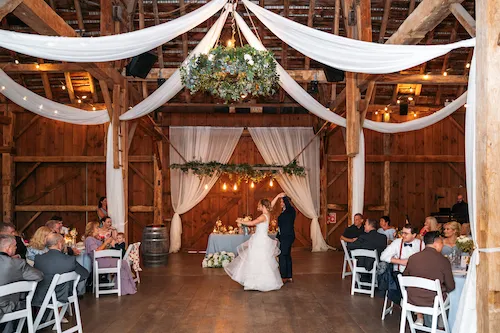 Bride and groom first dance in the barn at Maple Meadows Farm wedding reception