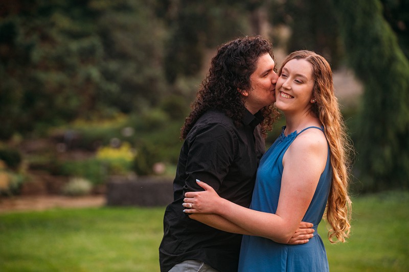 engagement shoot guy kissing girl on cheek 