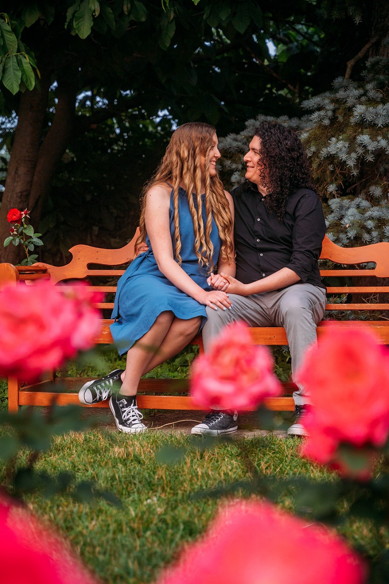 couple sitting surrounded by roses