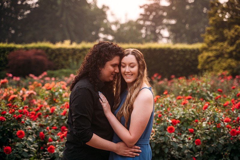 couple smiling at sunset in rose garden at botanical gardens