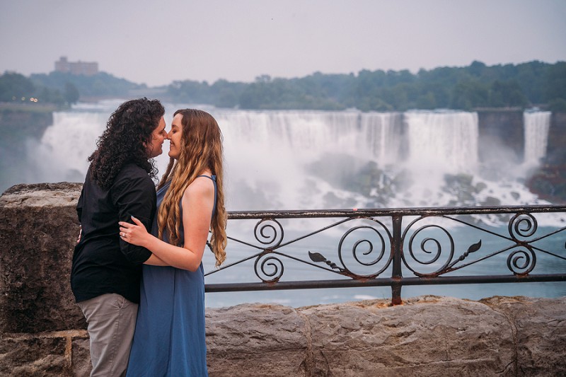 couple smiling with niagara falls in background