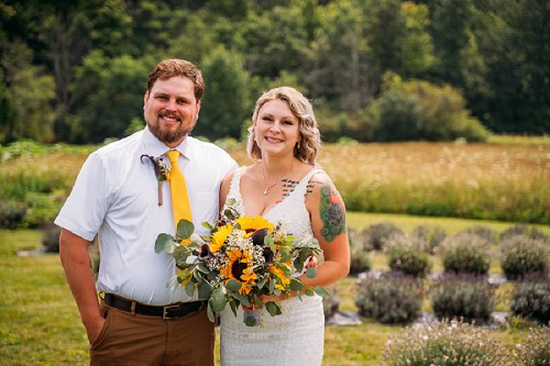 bride and groom smiling at camera