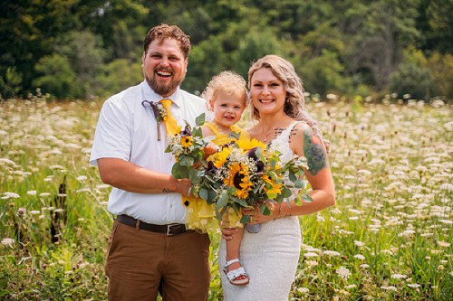portrait of couple with flower girl