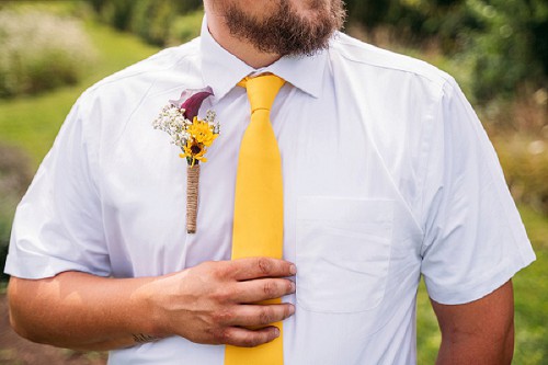 grooms yellow tie and flowers