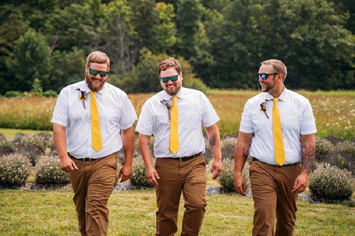 groom and groomsmen walking and laughing