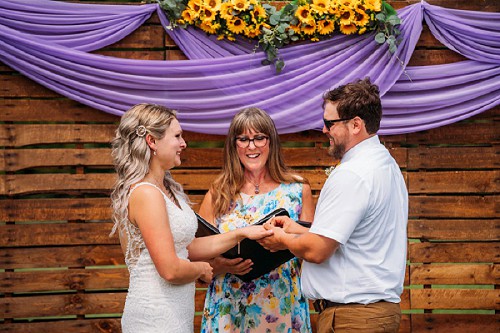 bride and groom exchanging rins