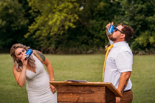 bride and groom shotgunning a beer