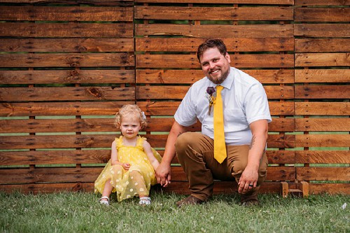 groom holding flower girls hand