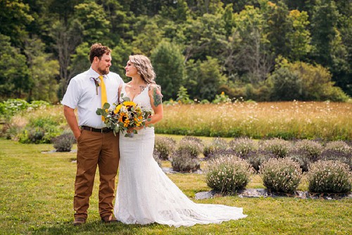 bride and groom staring at each other in a field