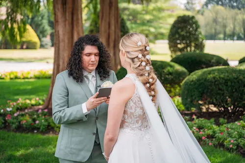 Groom reading private vows to his bride during first look