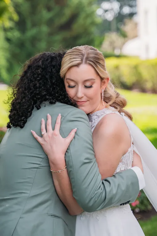 Bride and groom hugging after their emotional first look
