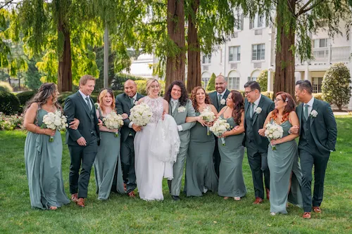 large wedding party in front of madison hotel