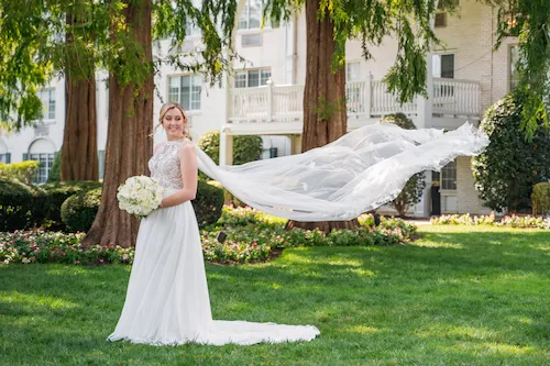 portrait of bride in front of the madison hotel with veil blowing in the wind
